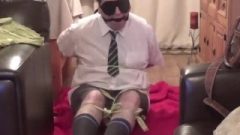 Dude Roped Up And Gagged Tightly In College Uniform With Strips Of Cloth