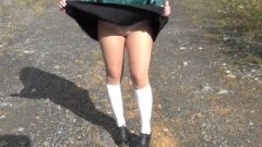 School-Girl In White Knee Socks And Chocolate Shoes Under The Skirt
